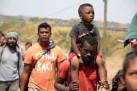 20240410. Tuxtla. Caravana de migrantes caminan bajo el sol del mediodía entre las ciudades de Berriozábal y Cintalapa.